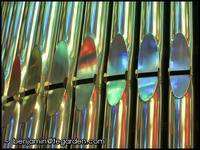 Stained glass reflections on organ pipes